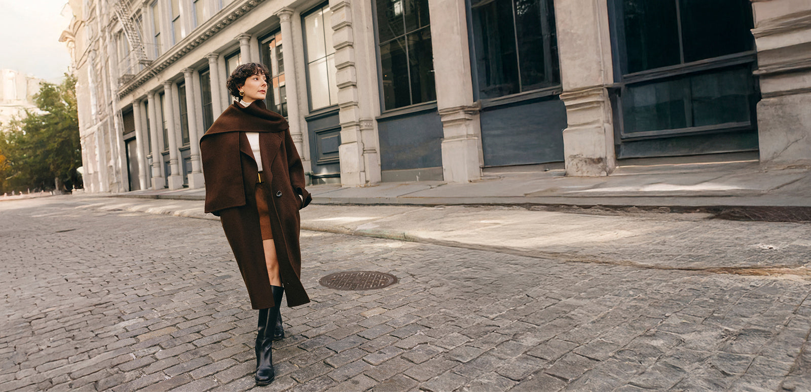 Influencer walking on streets of Soho in Mocha Wool coat by Petite Studio