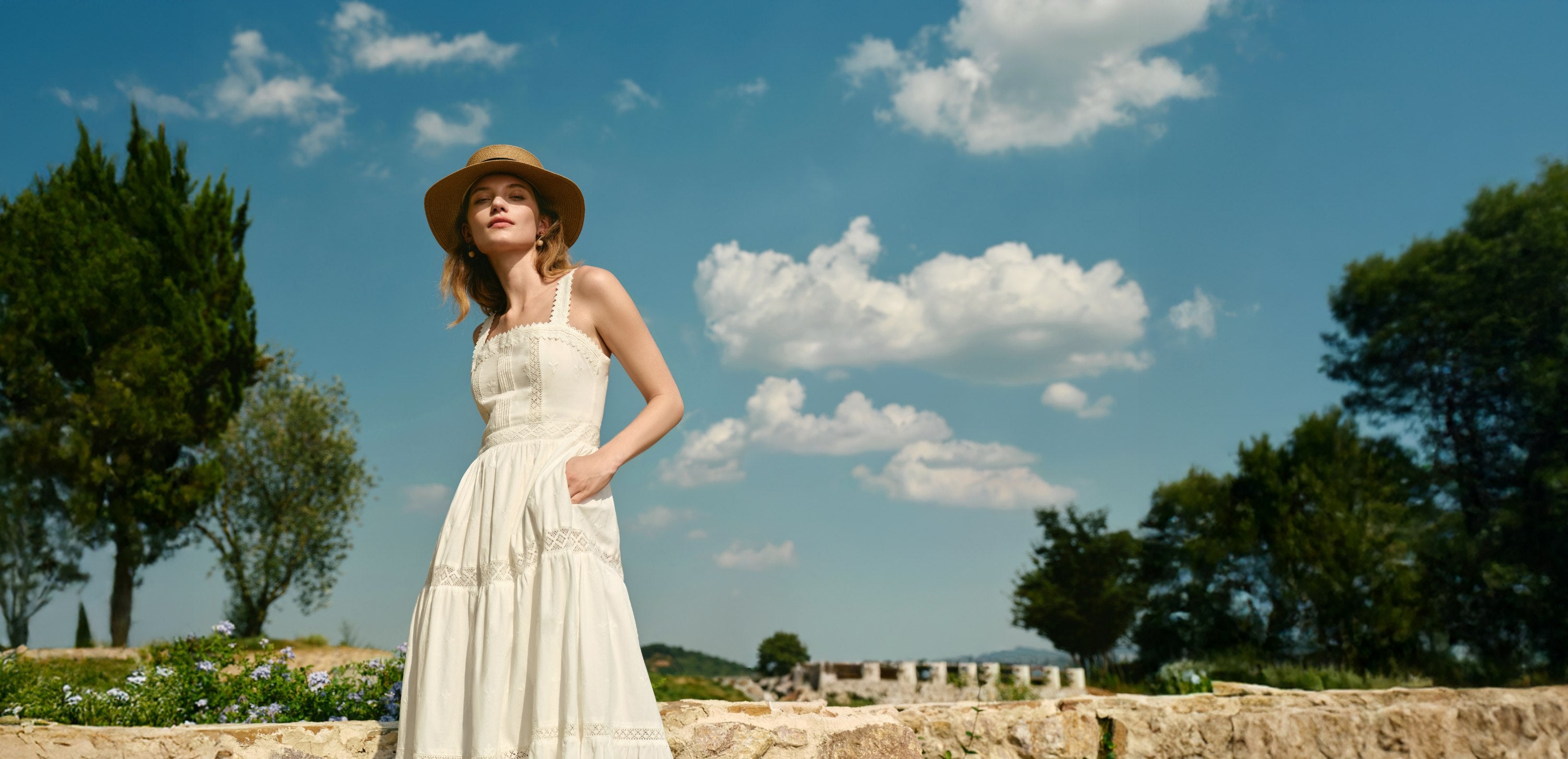Female model wearing Petite Studio dress in the South of France against cloudy sky